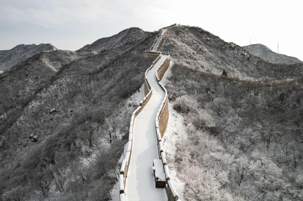 This photo shows an aerial view of a snow-covered section of the Great Wall of China at Shuiguan, north of Beijing, after an overnight snowfall on December 15, 2023. (Photo by Greg Baker / AFP)
