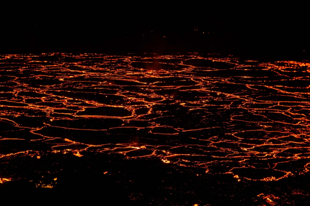  Molten lava is comming out from a fissure on the Reykjanes peninsula 3km north of the evacuate town of Grindavik, western Iceland on December 19, 2023. (Photo by Kristinn Magnusson / AFP) /