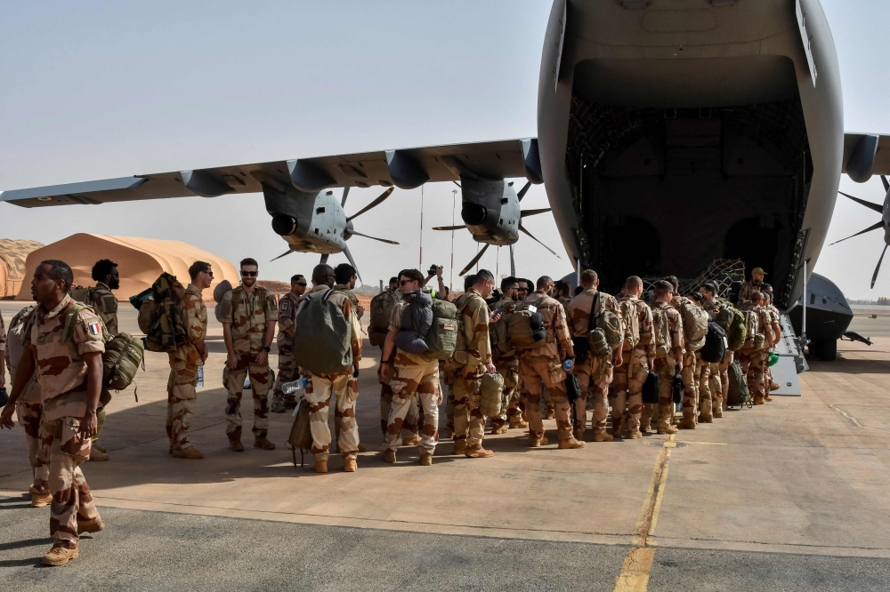 The last French soldiers board a French military plane to leave Niger for good, at the French base which was handed over to the Nigerien army, in Niamey on December 22, 2023. (Photo by Boureima Hama / AFP)