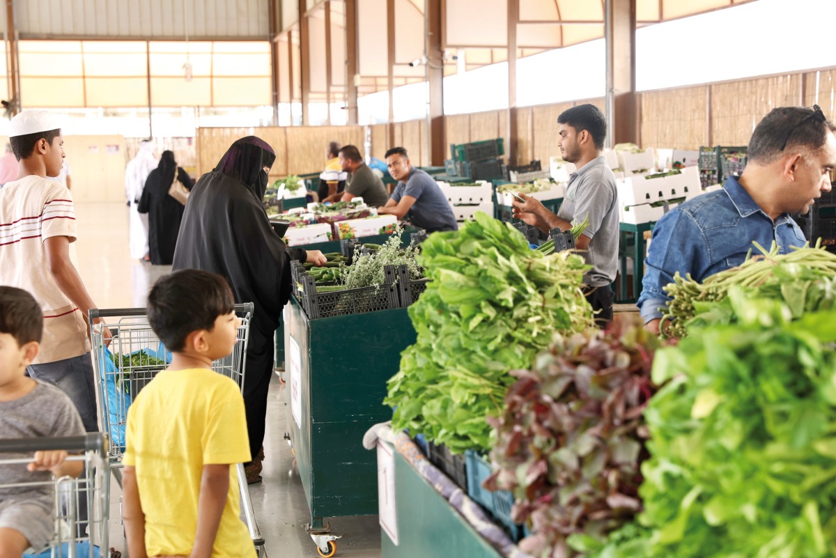 A file photo of customers buying vegetables at Al Mazrouah seasonal vegetable market.