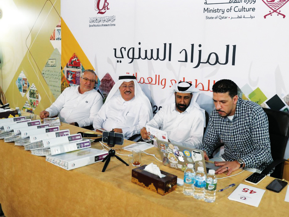 Officials during the annual auction of stamps and coins recently.