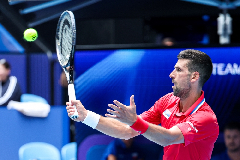 Serbia's Novak Djokovic hits a return to Czech Republic's Jiri Lehecka during their men's singles match during the United Cup tennis tournament in Perth on January 2, 2024. (Photo by COLIN MURTY / AFP)