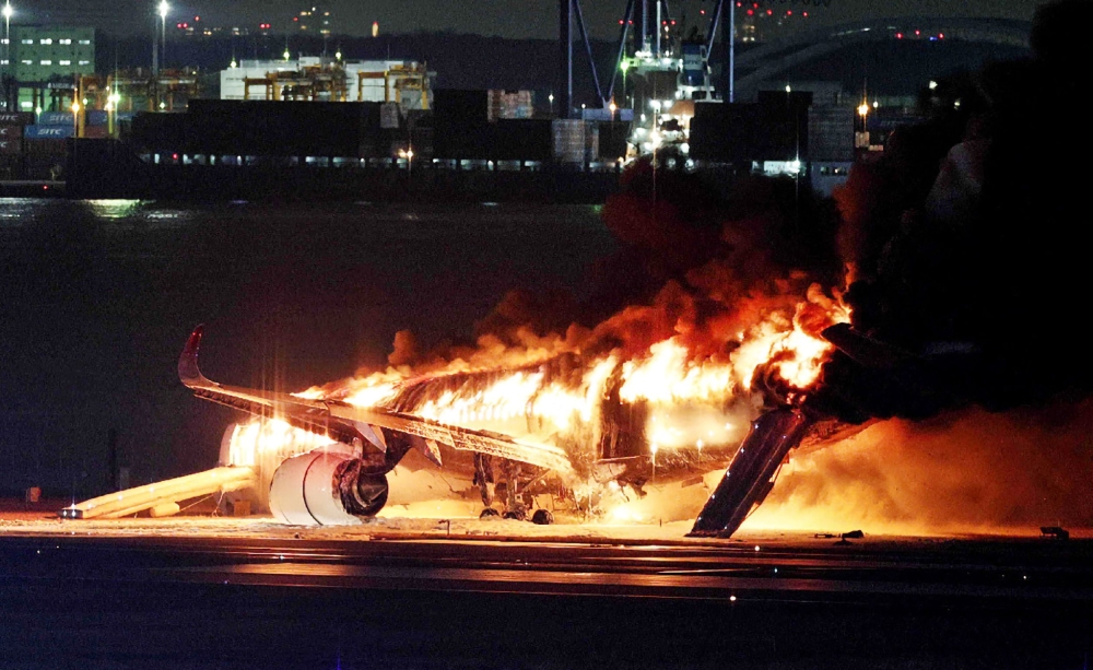 This photo provided by Jiji Press shows a Japan Airlines plane on fire on a runway of Tokyo's Haneda Airport on January 2, 2024. (Photo by Jiji Press / AFP) 