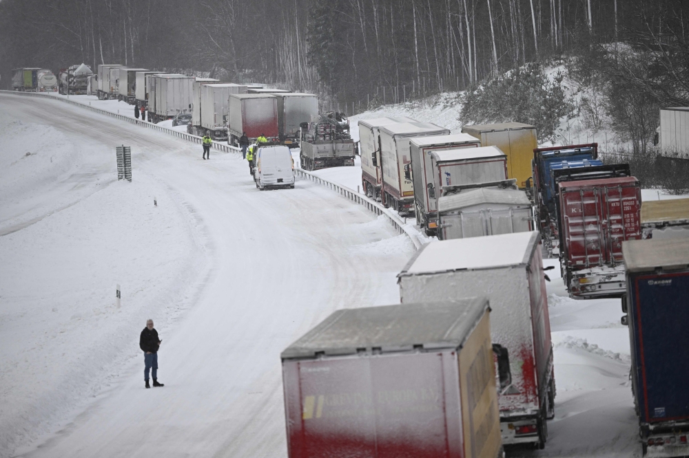 A large number of trucks are stuck on the E22 highway at Linderِd in southern Sweden on January 4, 2024. (Photo by Johan Nilsson/TT / TT News Agency / AFP) 