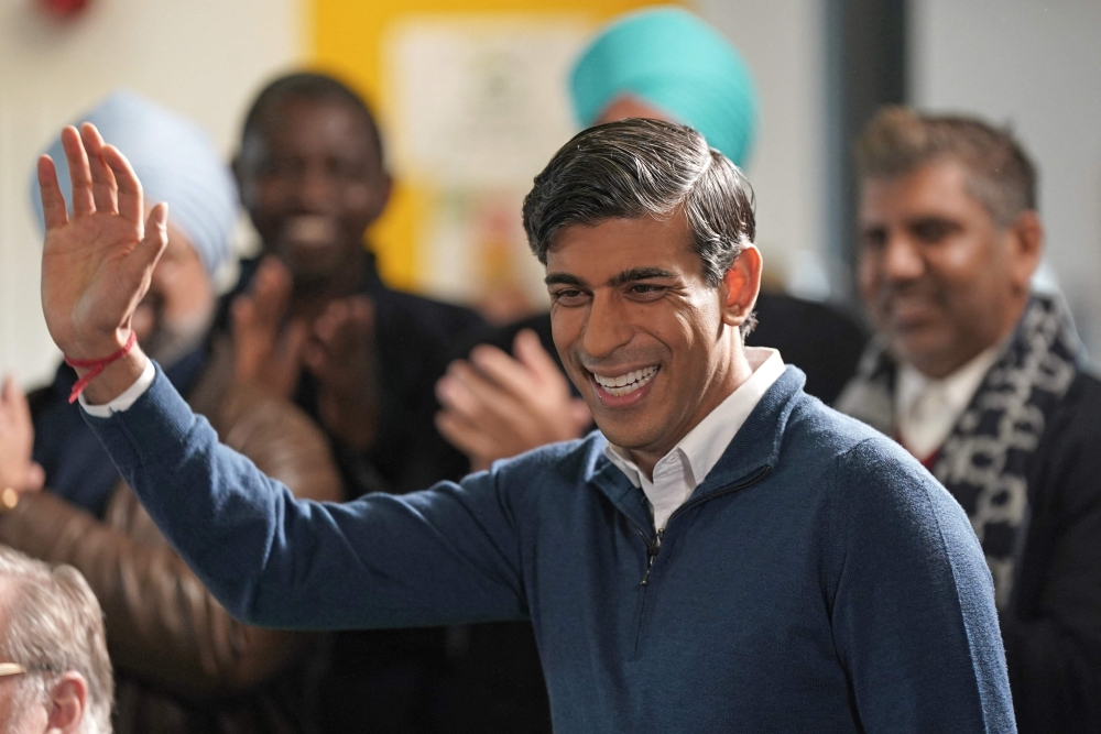 Britain's Prime Minister Rishi Sunak waves during a visit to the MyPlace Youth Centre, in Mansfield, in central England on January 4, 2024. (Photo by Jacob King / POOL / AFP)