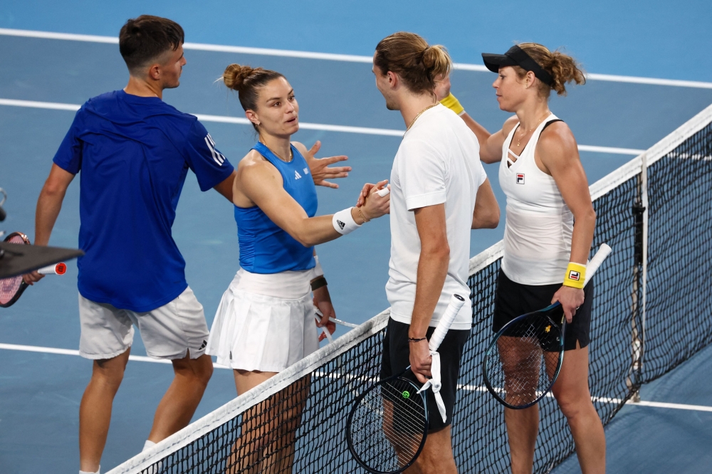 Germany's Laura Siegemund (R) and Alexander Zverev (2nd R) shake hands with Greece's Maria Sakkari and Petros Tsitsipas after victory during their mixed-doubles match at the United Cup tennis event on Ken Rosewall Arena in Sydney on January 5, 2024. Photo by DAVID GRAY / AFP