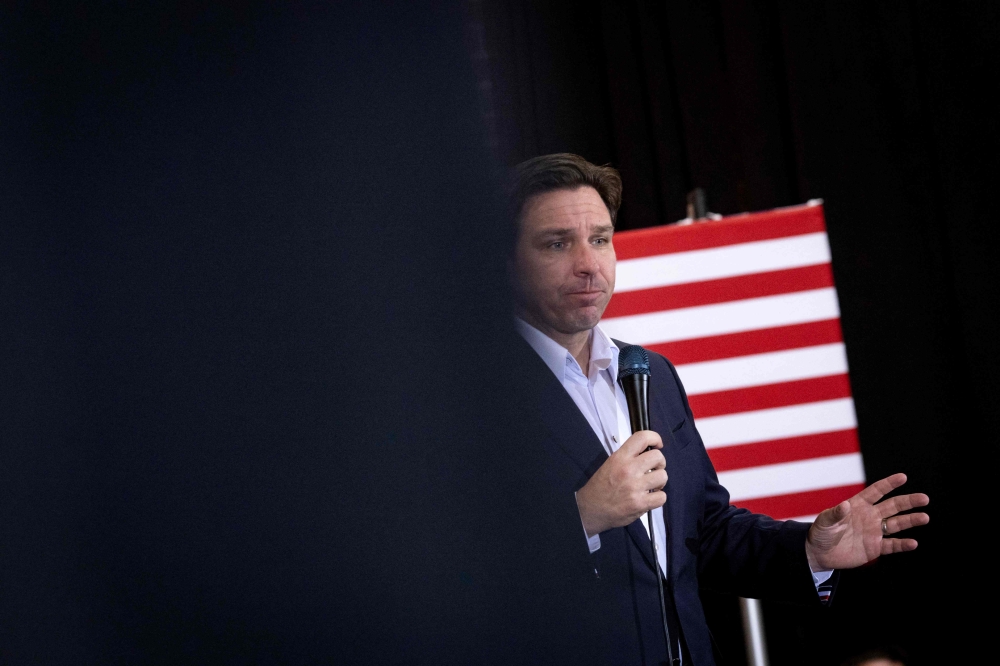 (FILES) Florida Governor and 2024 Republican presidential hopeful Ron DeSantis speaks at a campaign event in Davenport, Iowa, on January 13, 2024. (Photo by Christian MONTERROSA / AFP)

