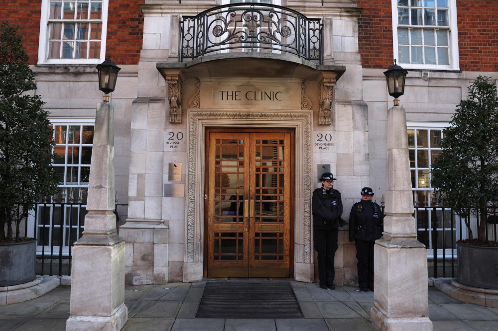 Police officers stand guard outside the London Clinic in London on January 26, 2024. (Photo by Daniel LEAL / AFP)
