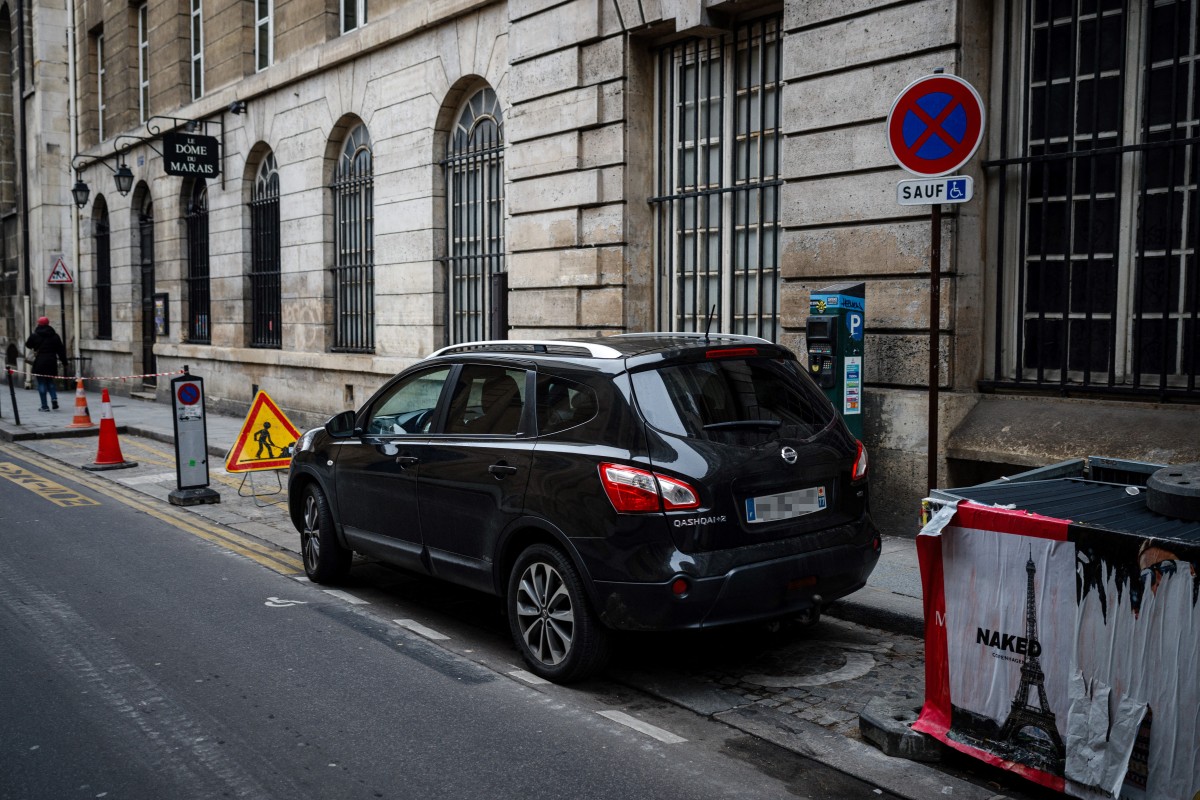 Cars are parked in Paris city center on February 2, 2024 as Paris' city hall is organizing a vote on February 4 on the creation of a special parking fee for heaviest and most polluting cars and SUVs. (Photo by Dimitar DILKOFF / AFP)