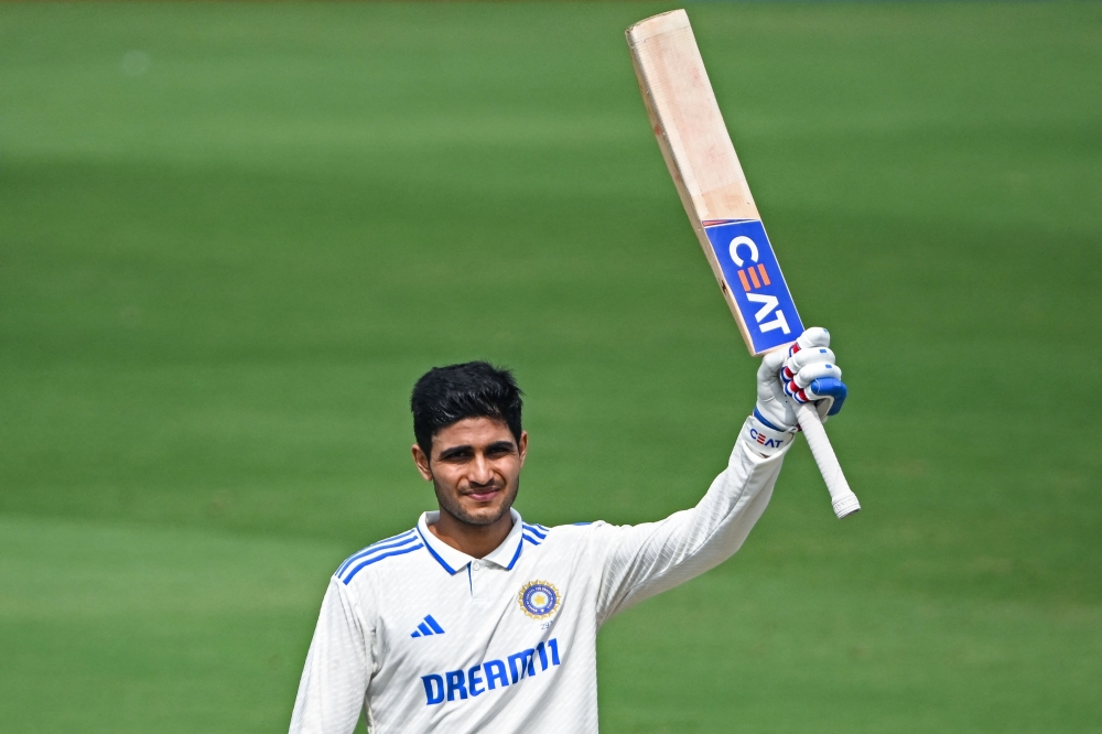 India's Shubman Gill celebrates after scoring a century at the YS Rajasekhara Reddy Cricket Stadium in Visakhapatnam on February 4, 2024. (Photo by Dibyangshu Sarkar / AFP)