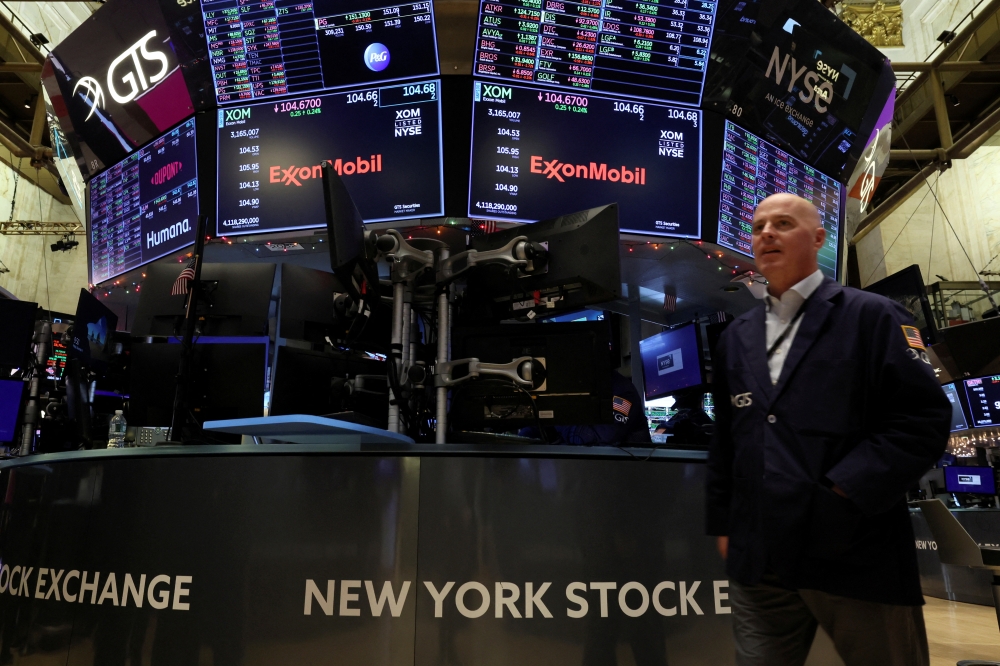 File photo: Screens display the trading information for ExxonMobil on the floor of the New York Stock Exchange (NYSE) in New York City, US, on December 9, 2022. REUTERS/Brendan McDermid

