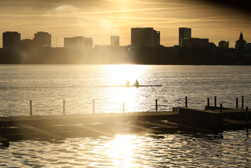 People paddle in the morning hours as the sun goes up in Hamburg on January 29, 2024. Photo by MORRIS MAC MATZEN / AFP