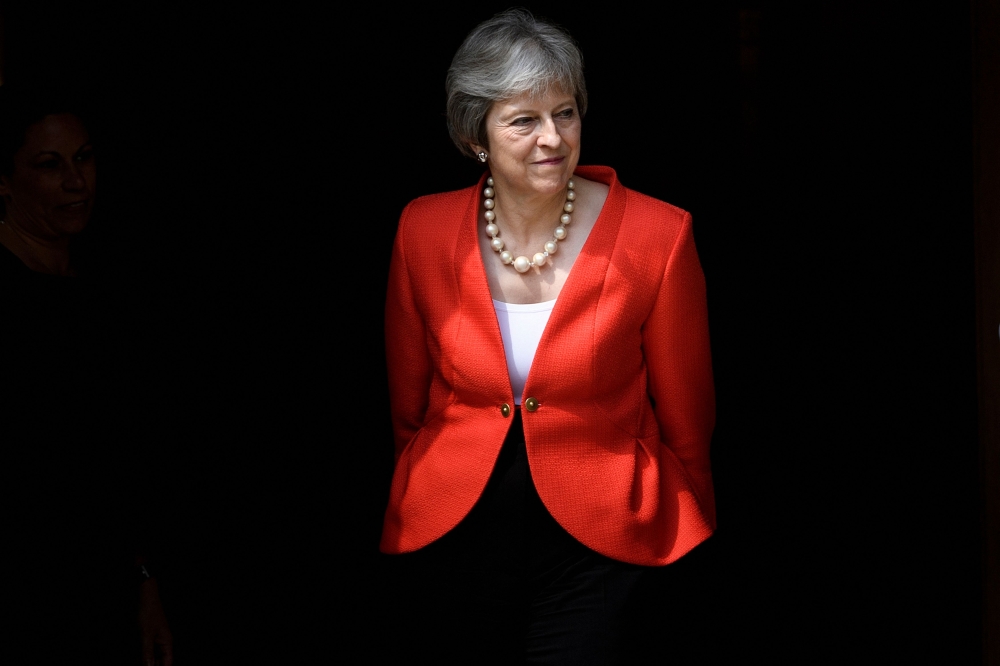 (FILES) Britain's Prime Minister Theresa May waits for the arrival of US President Donald Trump for a meeting at Chequers, the prime minister's country residence, near Ellesborough, northwest of London on July 13, 2018 on the second day of Trump's UK visit. (Photo by Brendan Smialowski / AFP)
