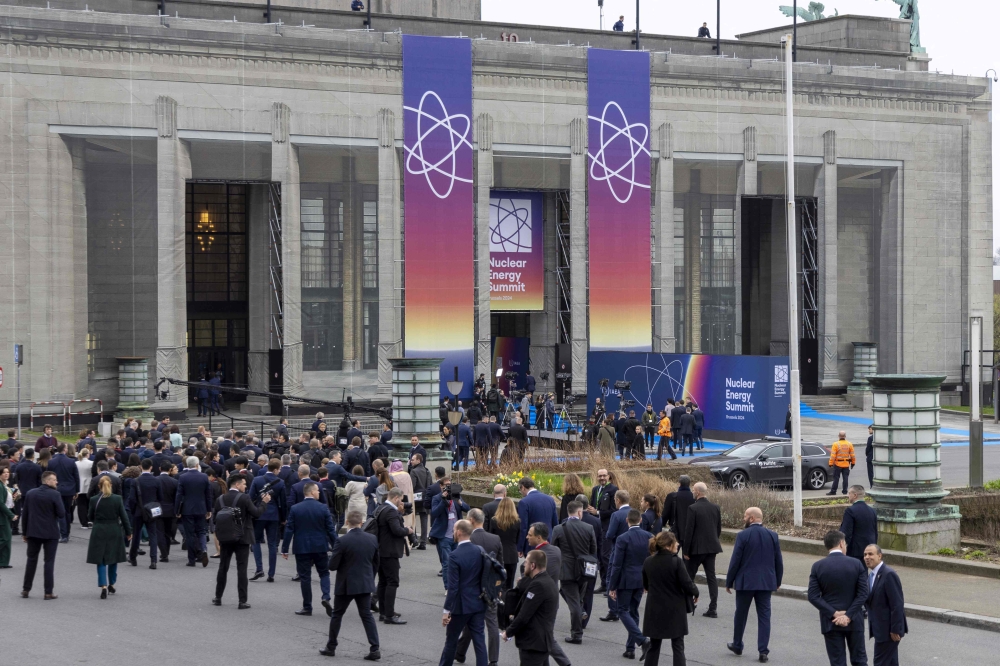 Attendees arrive for the International Atomic Energy Agency (IAEA) Nuclear Energy Summit at the Brussels Expo convention centre in Brussels on March 21, 2024. (Photo by Nicolas Maeterlinck / AFP)