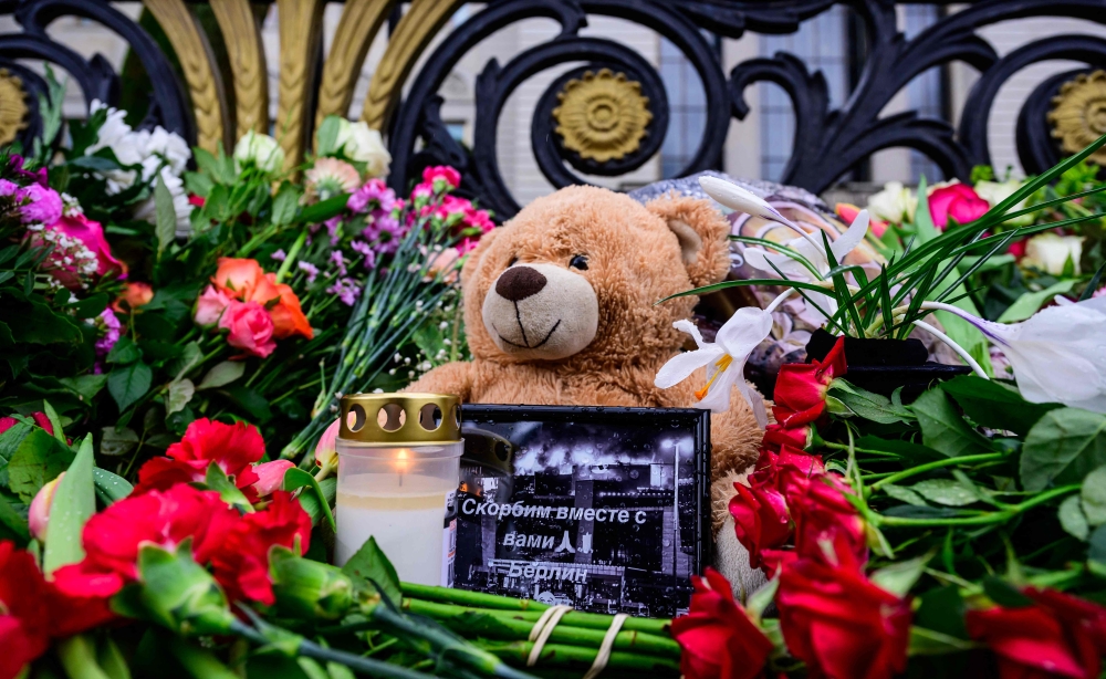 A photograph of a burning building inscribed with the words 
