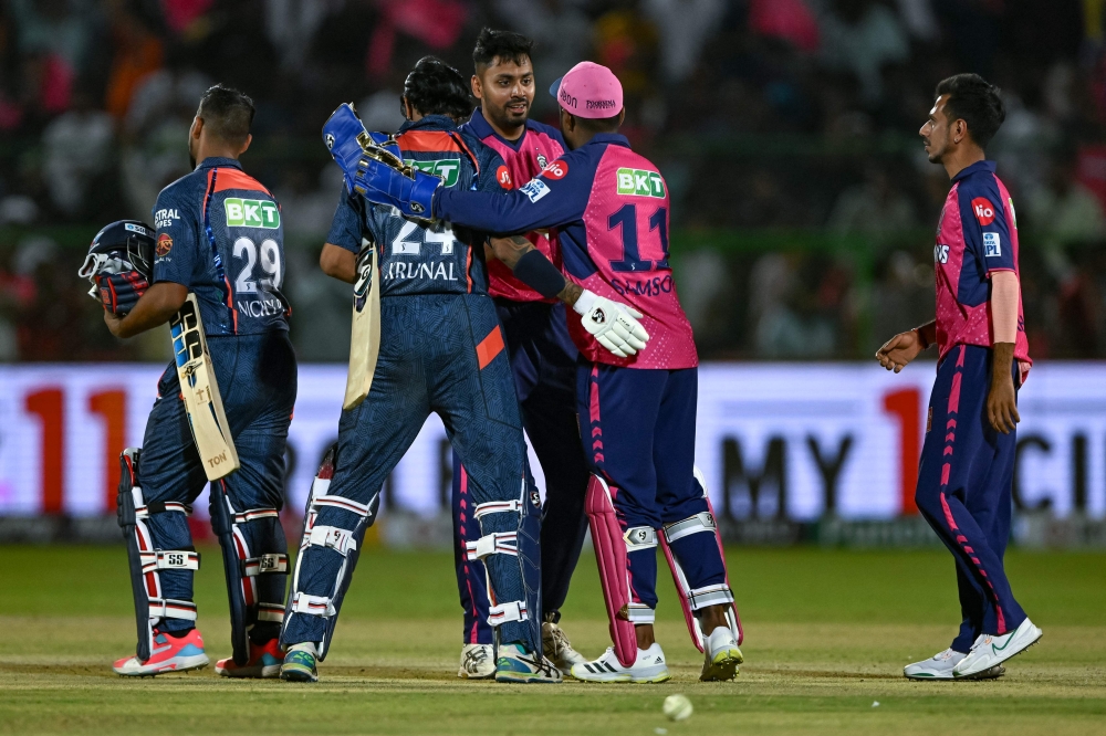 Rajasthan Royals' and Lucknow Super Giants' players greet each other at the end of the Indian Premier League (IPL) Twenty20 cricket match between Rajasthan Royals and Lucknow Super Giants at the Sawai Mansingh Stadium in Jaipur on March 24, 2024. (Photo by Arun SANKAR / AFP)