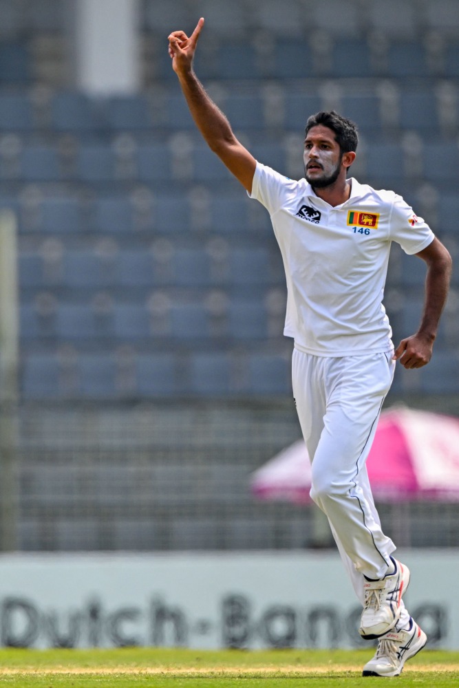 Sri Lanka's Kasun Rajitha celebrates after taking the wicket of Bangladesh's Mehidy Hasan Miraz during the fourth day of the first Test cricket match between Bangladesh and Sri Lanka at the Sylhet International cricket Stadium in Sylhet on March 25, 2024. (Photo by MUNIR UZ ZAMAN / AFP)