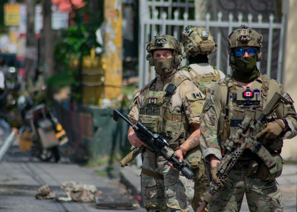Canadian soldiers stand guard in front of their embassy in Port-au-Prince, Haiti, on March 28 2024.  (Photo by Clarens Siffroy / AFP)
