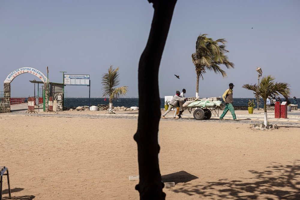 Senegal daily life; Men transport building materials on a cart on Goree Island, on March 29, 2024. Photo by MARCO LONGARI / AFP.