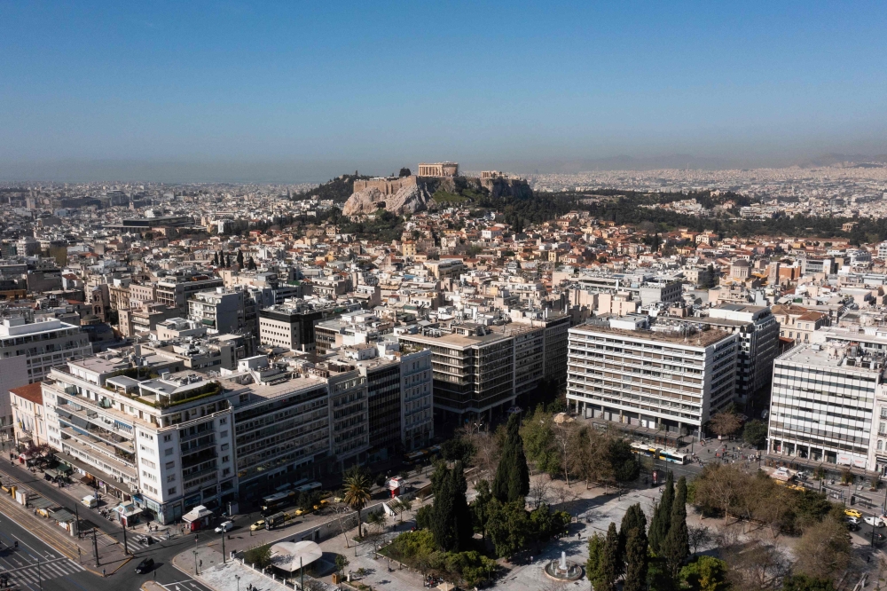 This aerial photograph taken on March 30, 2024 shows in the background Parthenon ancient temple on the top of the Acropolis hill in Athens. Photo by Aris MESSINIS / AFP