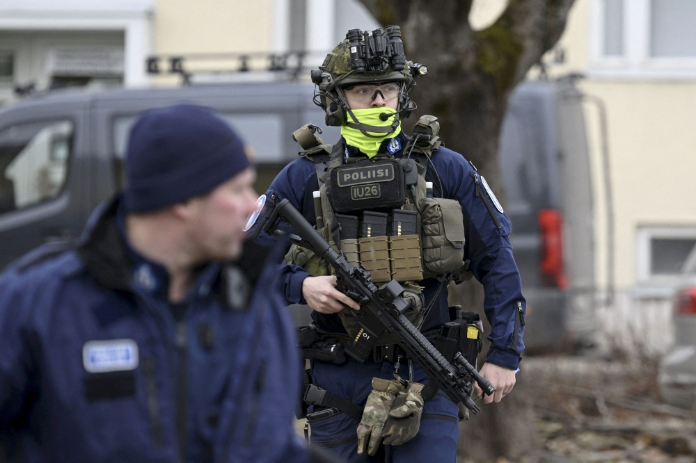 Finnish police officers investigate at the primary Viertola comprehensive school where a child opened fire and injured three other children, on April 2, 2024 in Vantaa, outside the Finnish capital Helsinki. Photo by Markku Ulander / Lehtikuva / AFP.