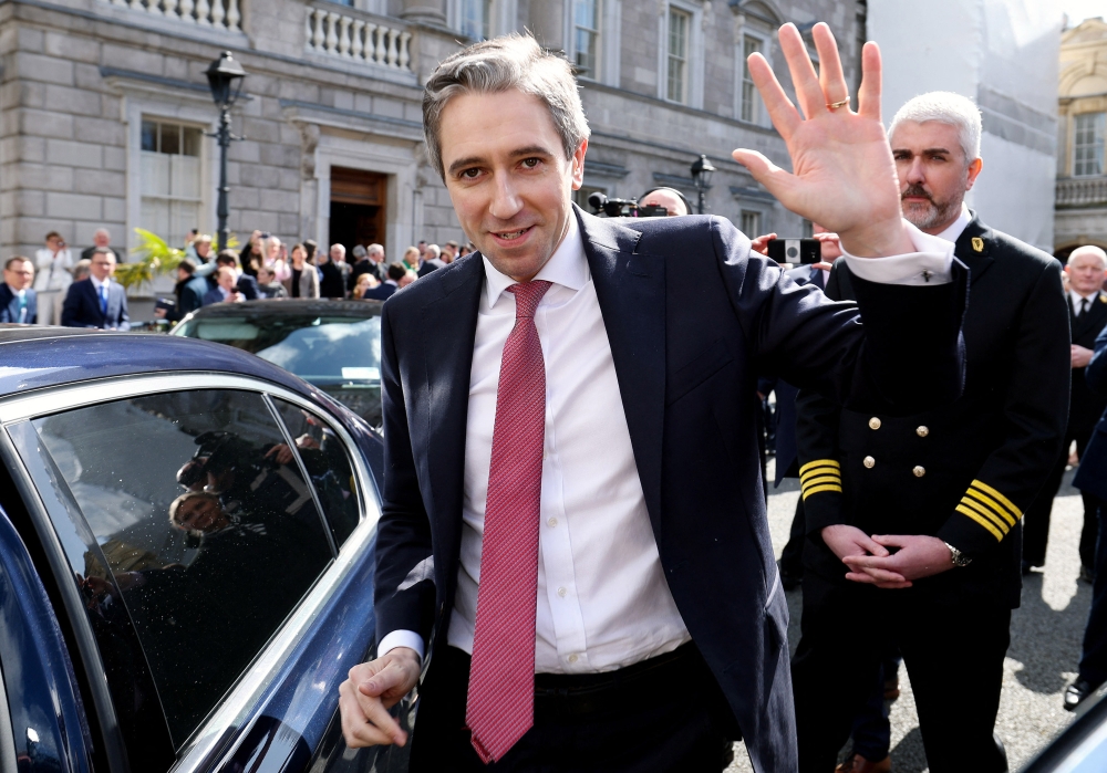 A handout photograph taken on, and released by Ireland's Houses of the Oireachtas on April 9, 2024 shows Fine Gael leader and Ireland's incoming Prime Minster, Simon Harris (C) waving as he he leaves from Leinster House, the seat of the Irish Parliament, after being voted in as Ireland's new Prime Minister. Photo by MAXWELLS / HOUSES OF THE OIREACHTAS / AFP.