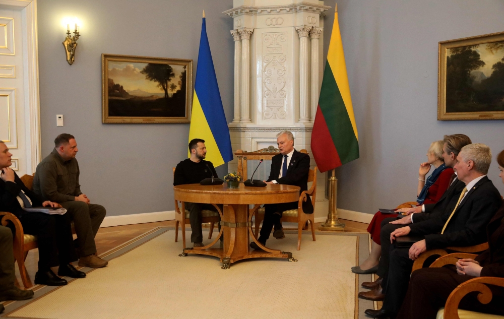 Lithuania's President Gitanas Nauseda (R) and Ukraine's President Volodymyr Zelensky have taken seat for talks at the Presidential Palace in Vilnius, Lithuania, on April 11, 2024.  (Photo by Petras Malukas / AFP)