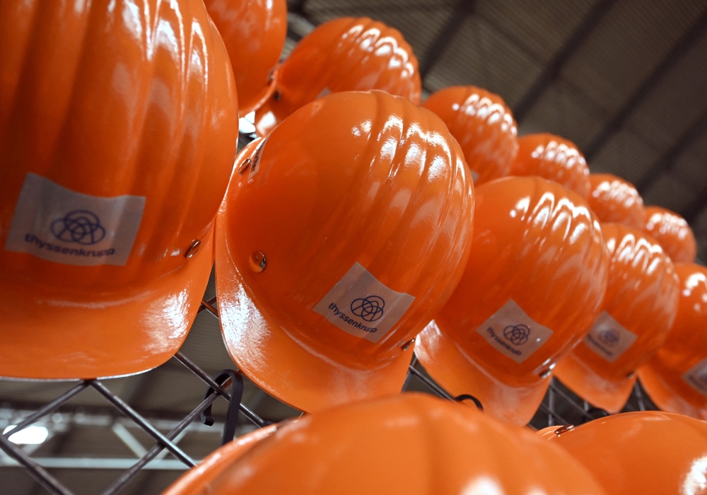 (FILES) Hard hats of employees are pictured at the hot strip production at the Thyssenkrupp Steel Europe in Duisburg, western Germany on May 2, 2023. (Photo by Ina FASSBENDER / AFP)
