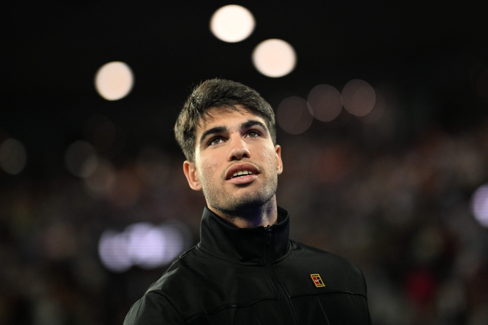 Spain's Carlos Alcaraz walks off the court after the men's singles match against Serbia's Miomir Kecmanovic on day nine of the Australian Open tennis tournament in Melbourne on January 22, 2024. (Photo by Anthony WALLACE / AFP)


