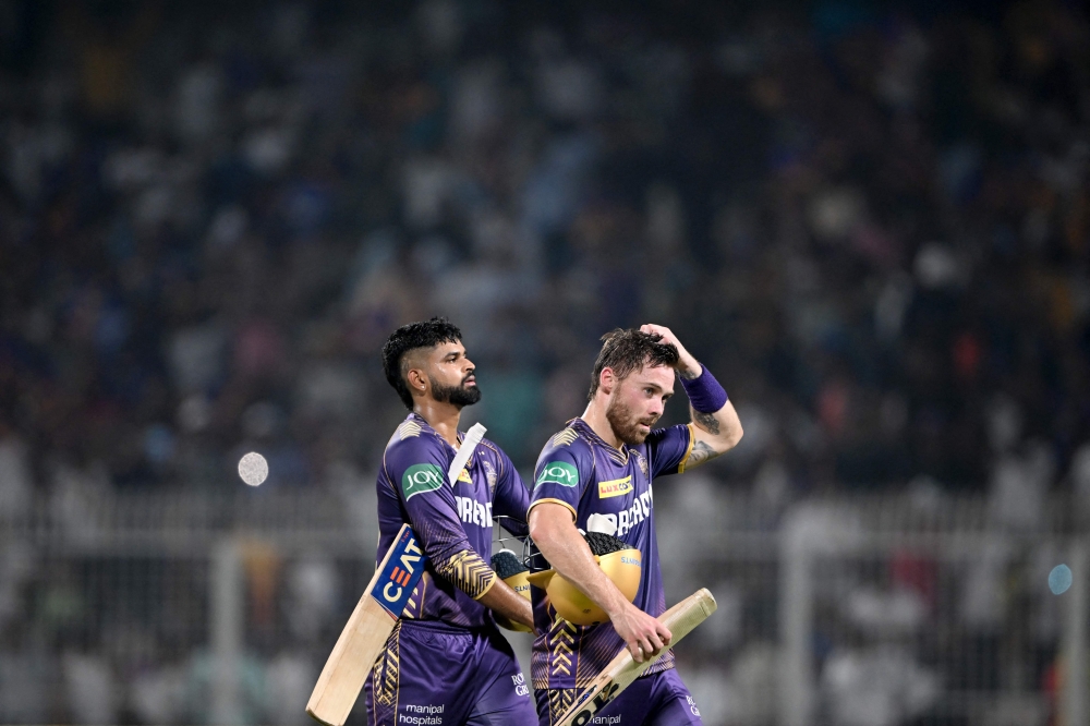 Kolkata Knight Riders' captain Shreyas Iyer (L) and Phil Salt walks back to the pavilion after their win against Lucknow Super Giants at the end of their Indian Premier League (IPL) Twenty20 cricket match in the Eden Gardens of Kolkata on April 14, 2024. (Photo by DIBYANGSHU SARKAR / AFP)
