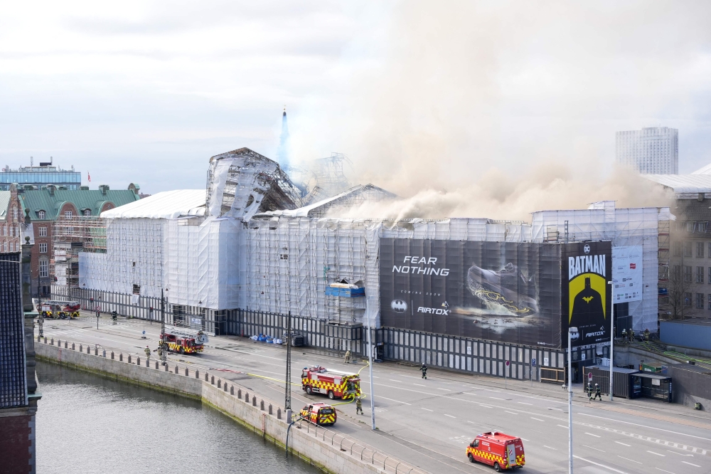 Plumes of smoke billow from the historic Boersen stock exchange building which is on fire in central Copenhagen, Denmark on April 16, 2024. (Photo by Emil Helms / Ritzau Scanpix / AFP) 