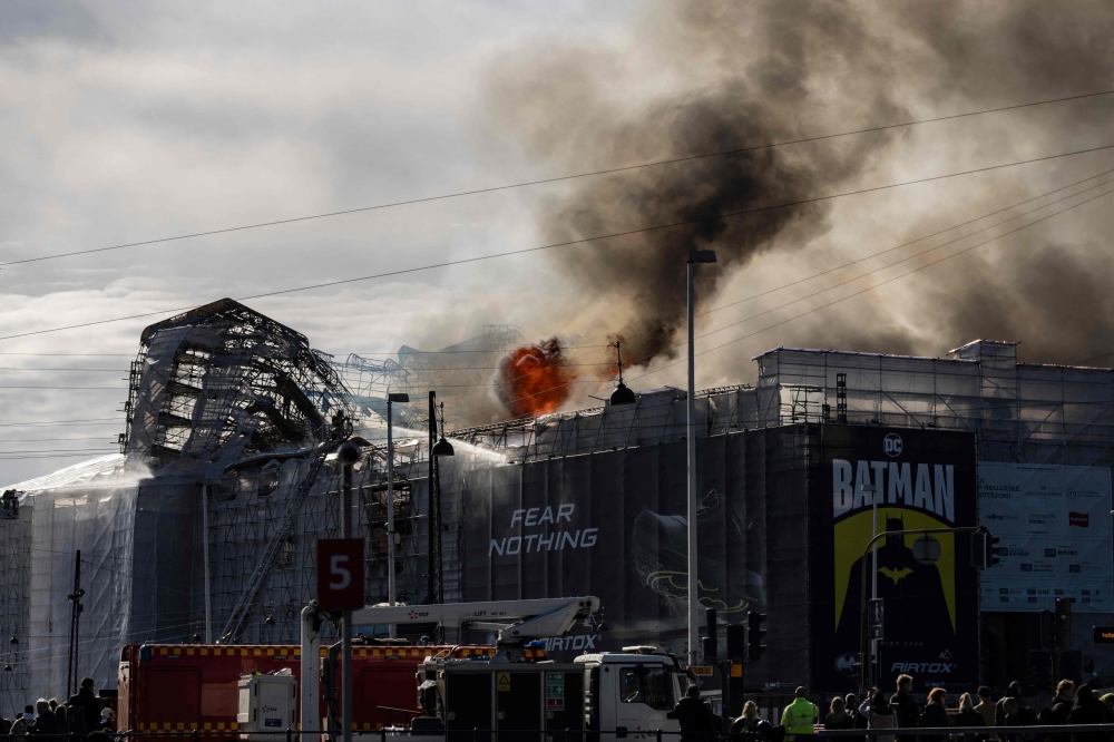 Plumes of smoke billow from the historic Boersen stock exchange building which is on fire in central Copenhagen, Denmark on April 16, 2024. Photo by Emil Nicolai Helms / Ritzau Scanpix / AFP