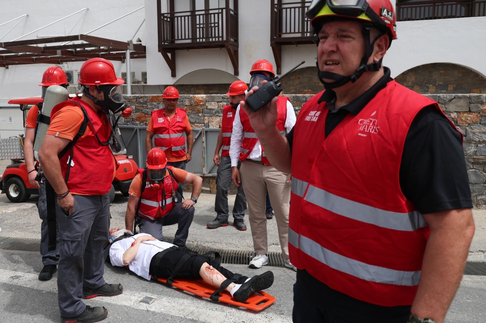 Emergency staff treat a volunteer roleplaying as an injured victim as they take part in the earthquake drill 