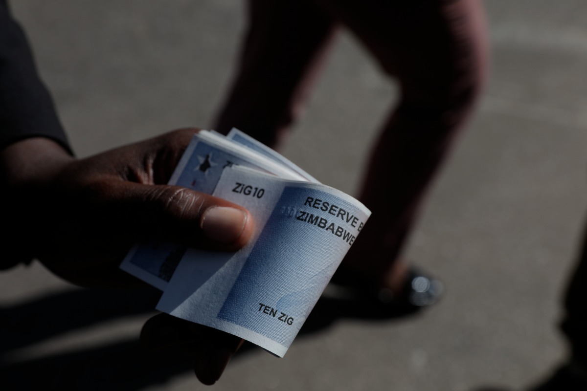 HARARE, April 30, 2024 (Xinhua) -- A man shows new currency Zimbabwe Gold banknotes outside a bank in Harare, Zimbabwe, on April 30, 2024.