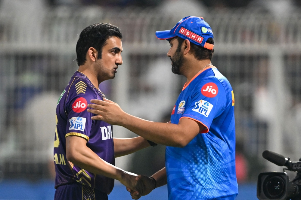 Mumbai Indians' Rohit Sharma (R) greets Kolkata Knight Riders' mentor Gautam Gambhir at the end of the Indian Premier League (IPL) Twenty20 cricket match between Kolkata Knight Riders and Mumbai Indians at the Eden Gardens in Kolkata on May 11, 2024. (Photo by DIBYANGSHU SARKAR / AFP)