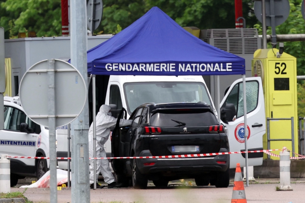 A forensic is at work at the site of a ramming attack which took place late morning at a road toll in Incarville in the Eure region of northern France, on May 14, 2024. Photo by ALAIN JOCARD / AFP.