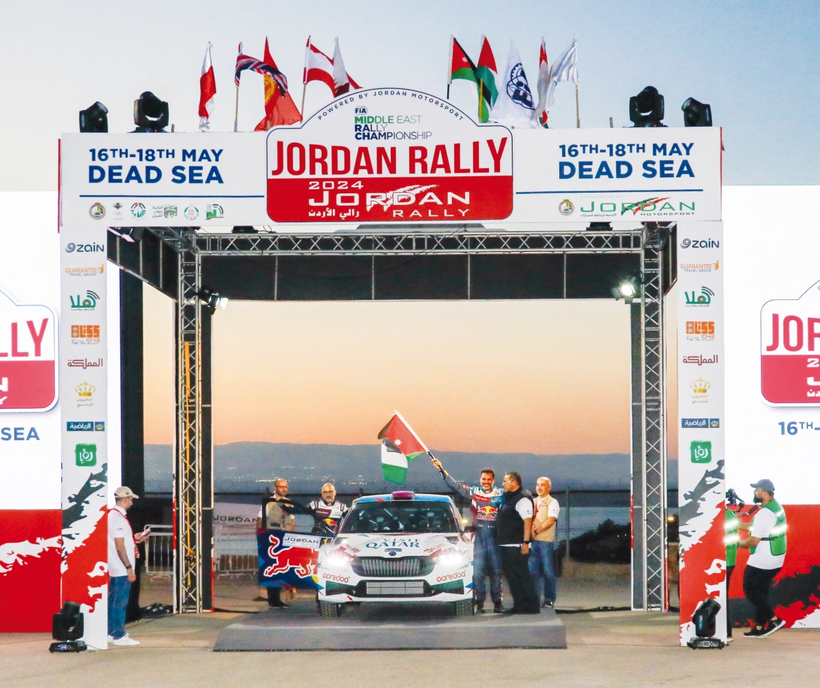 Qatar's Nasser Saleh Al Attiyah waves a flag at the start of the Jordan Rally, yesterday.