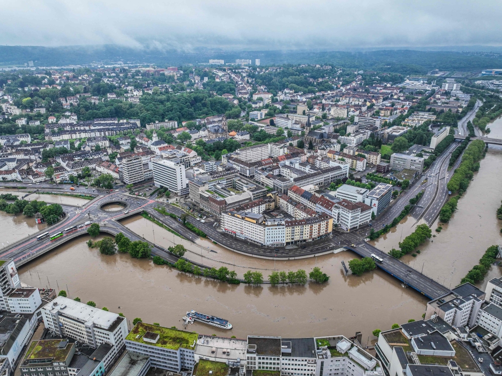 An aerial view taken on May 18, 2024, in Saarbruecken, western Germany, shows the city motorway A620 partially inundated along the Saar River after heavy rains caused flooding, swamping streets and buildings and sparking evacuations in south west Germany. (Photo by Laszlo Pinter / DPA / AFP) 