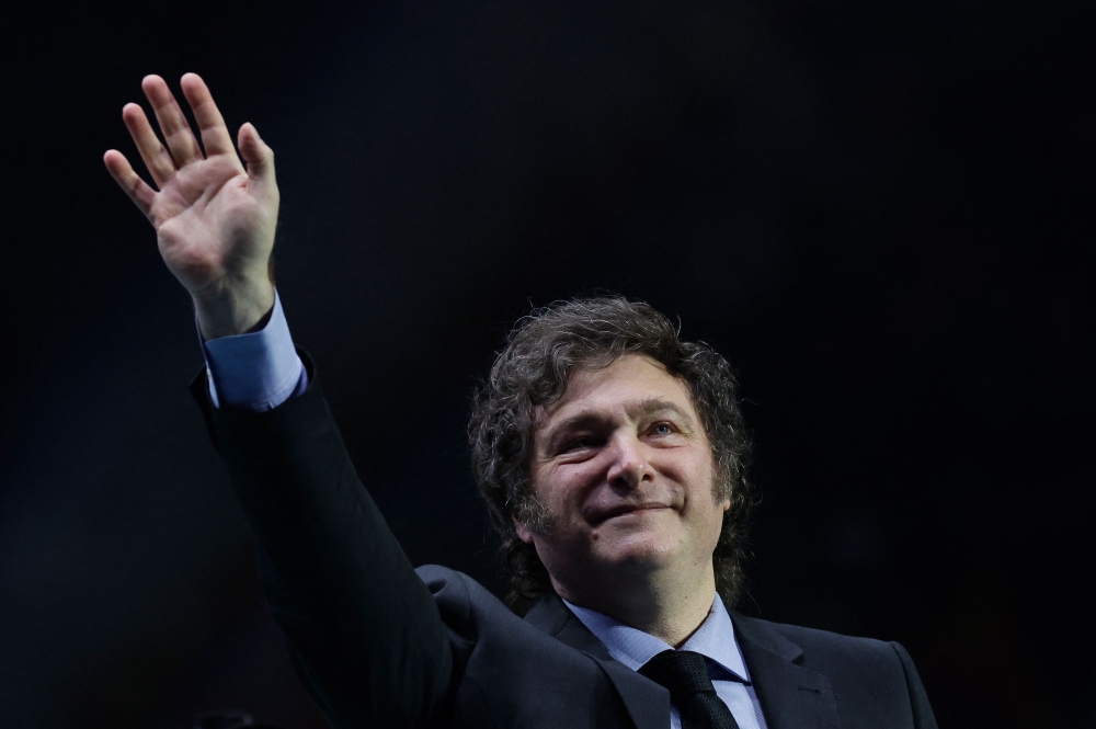 Argentina's president Javier Milei gestures as he delivers a speech on stage during the Spanish far-right wing party Vox's rally 