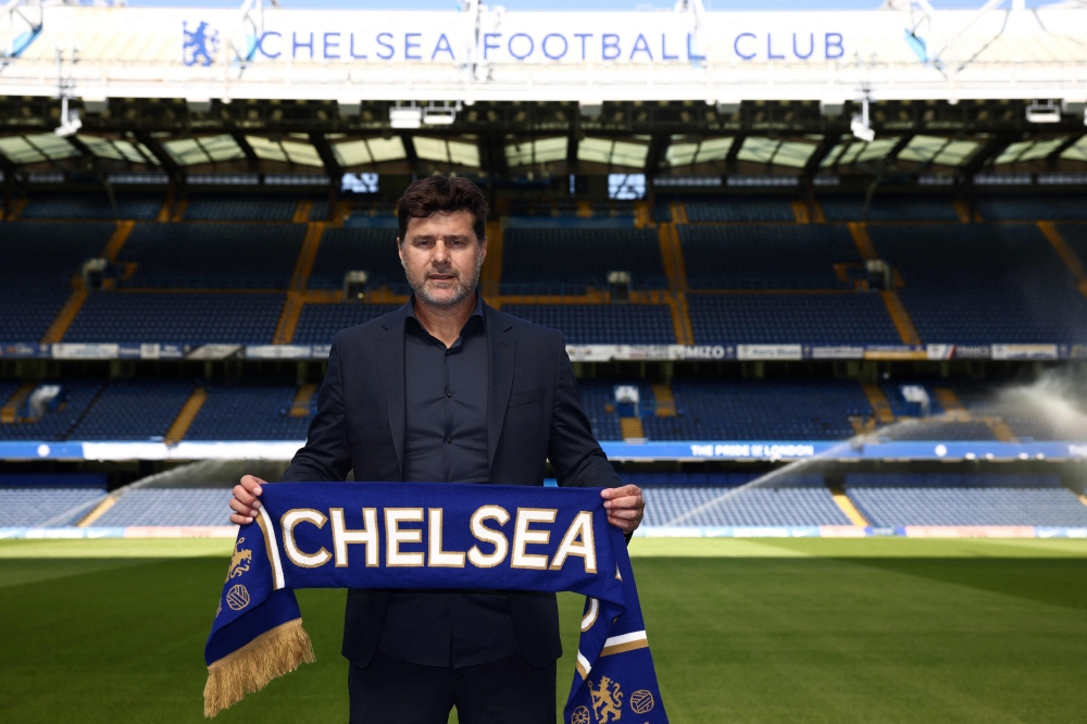 File: Chelsea's Argentinian head coach Mauricio Pochettino poses for a photograph with a Chelsea scarf beside the pitch at Stamford Bridge in London on July 7, 2023, as he is introduced to the media as the new Chelsea Head Coach. (Photo by Henry Nicholls / AFP)