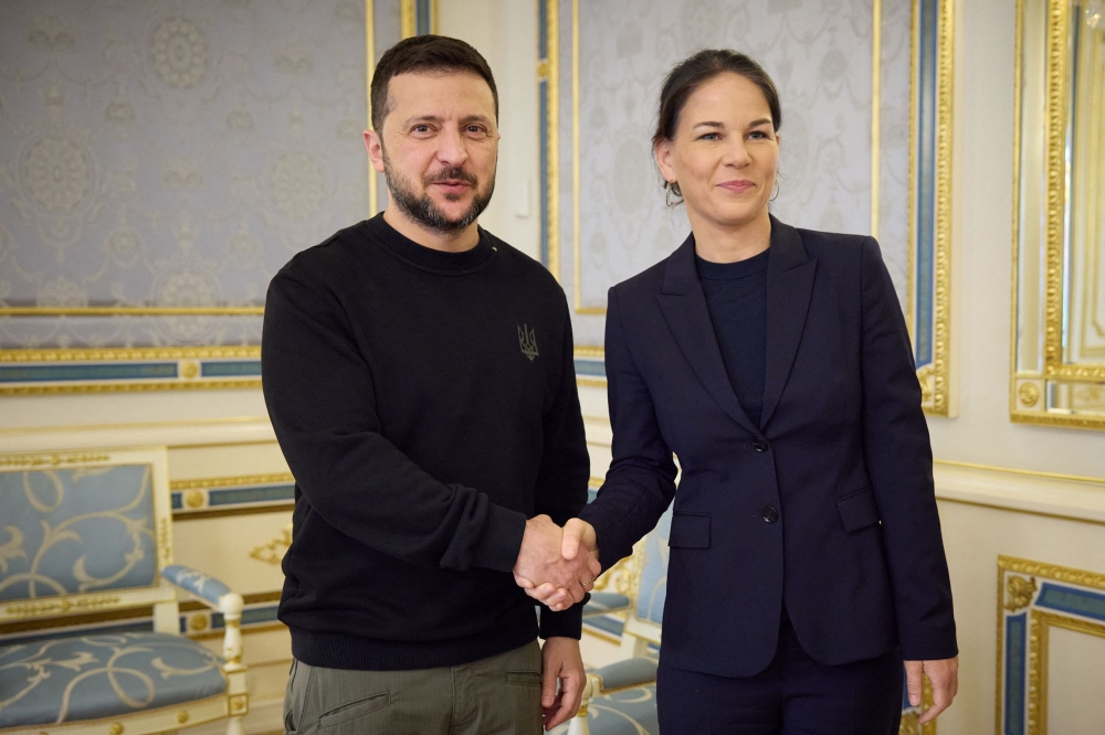 This handout photograph taken and released by the Ukrainian Presidential Press Service on May 21, 2024, shows Ukraine's President Volodymyr Zelensky (left) shaking hands with Germany's Foreign Minister Annalena Baerbock prior to their talks in Kyiv. (Photo by Handout / UKRAINIAN PRESIDENTIAL PRESS SERVICE / AFP)
