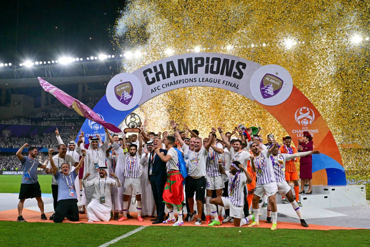 Ain's players celebrate with the winner's trophy after the second leg of the AFC Champions League Final between UAE's Al Ain and Japan's Yokohama F. Marinos at the Hazza Bin Zayed Stadium in Al-Ain on May 25, 2024. (Photo by Giuseppe CACACE / AF