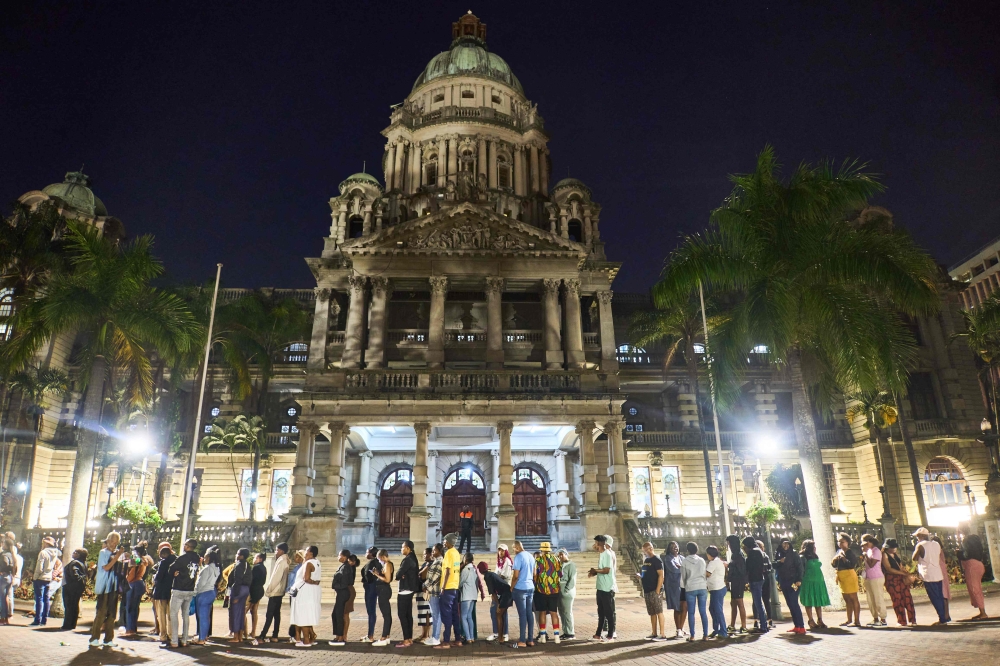 Voters wait in line at night outside the city hall voting station in Durban on May 29, 2024. (Photo by Zinyange Auntony / AFP)