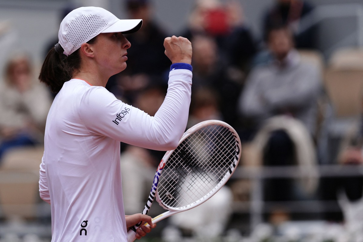 Poland's Iga Swiatek reacts after a point during her women's singles round of sixteen match against Russia's Anastasia Potapova on Court Philippe-Chatrier on day eight of the French Open tennis tournament at the Roland Garros Complex in Paris on June 2, 2024. (Photo by Dimitar DILKOFF / AFP)
