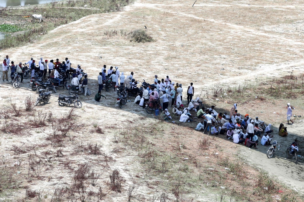 People take rest under the shade of a bridge to shelter from the scorching sun on a hot summer day along the banks of river Ganges in Prayagraj on June 3, 2024. (Photo by Anil Shakya / AFP)
 