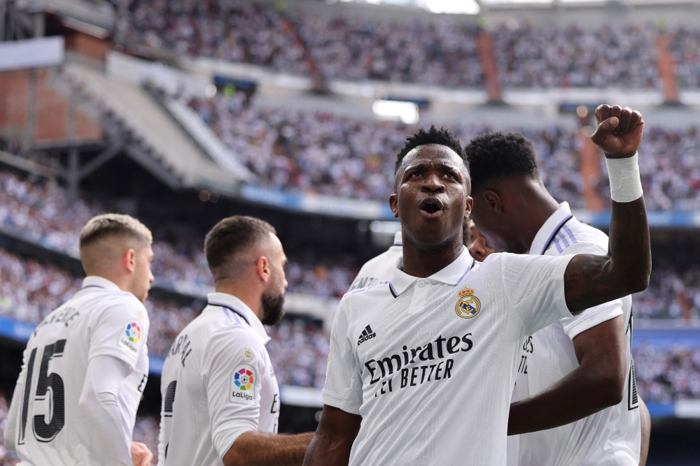 File: Real Madrid's Brazilian forward #07 Vinicius Junior lifts his fist as he celebrates during the Spanish League football match between Real Madrid CF and FC Barcelona at the Santiago Bernabeu stadium in Madrid on October 16, 2022. (Photo by Thomas Coex / AFP)