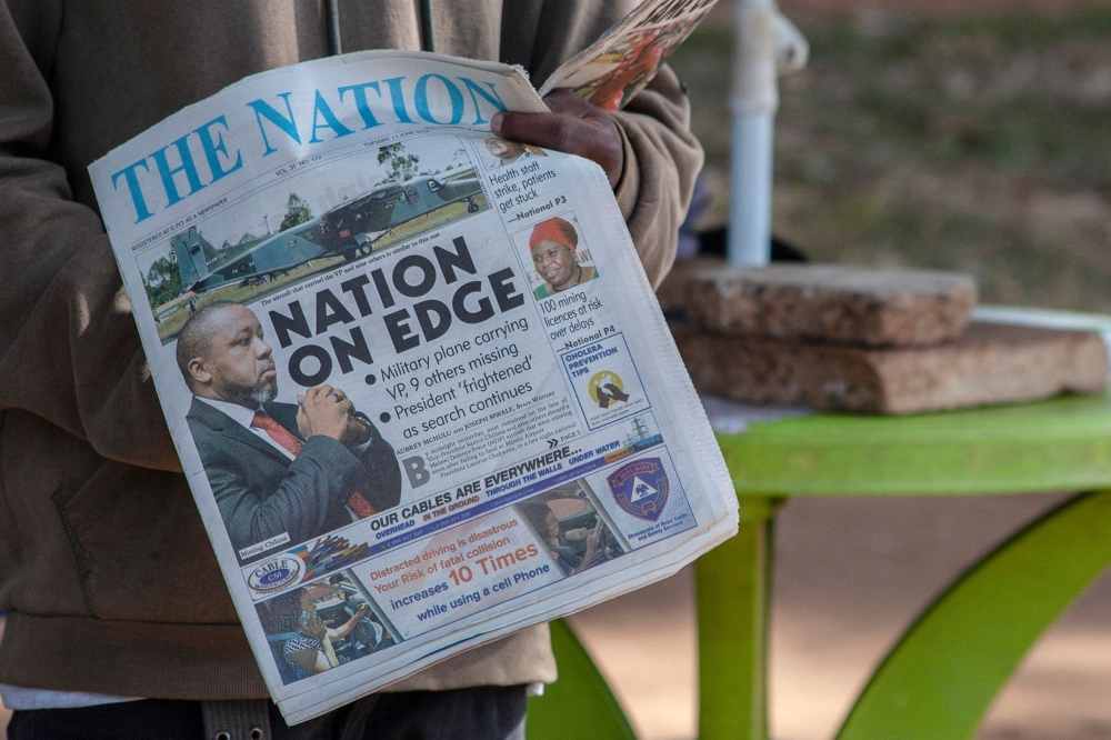 A newspaper vendor holds The Nation newspaper with a cover picture of the missing plane Vice State President Saulos Klaus Chilima in Lilongwe, on June 11, 2024. Photo by Amos Gumulira / AFP