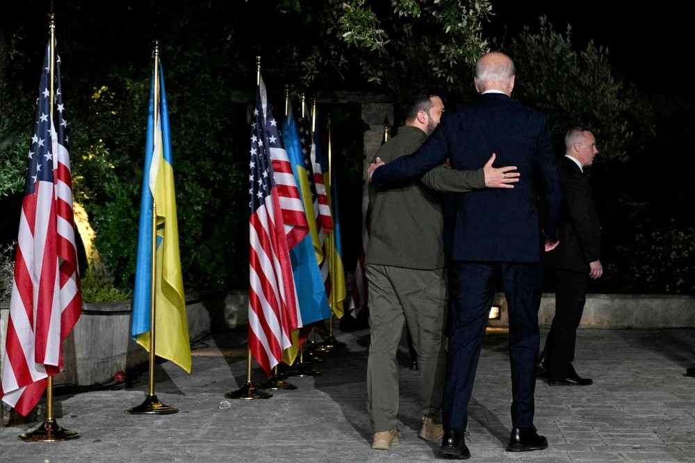 Ukrainian President Volodymyr Zelensky (left) and US President Joe Biden leave after signing a security agreement during a press conference at the Masseria San Domenico on the sidelines of the G7 Summit hosted by Italy in Apulia region, on June 13, 2024 in Savelletri. (Photo by Mandel Ngan / AFP)


