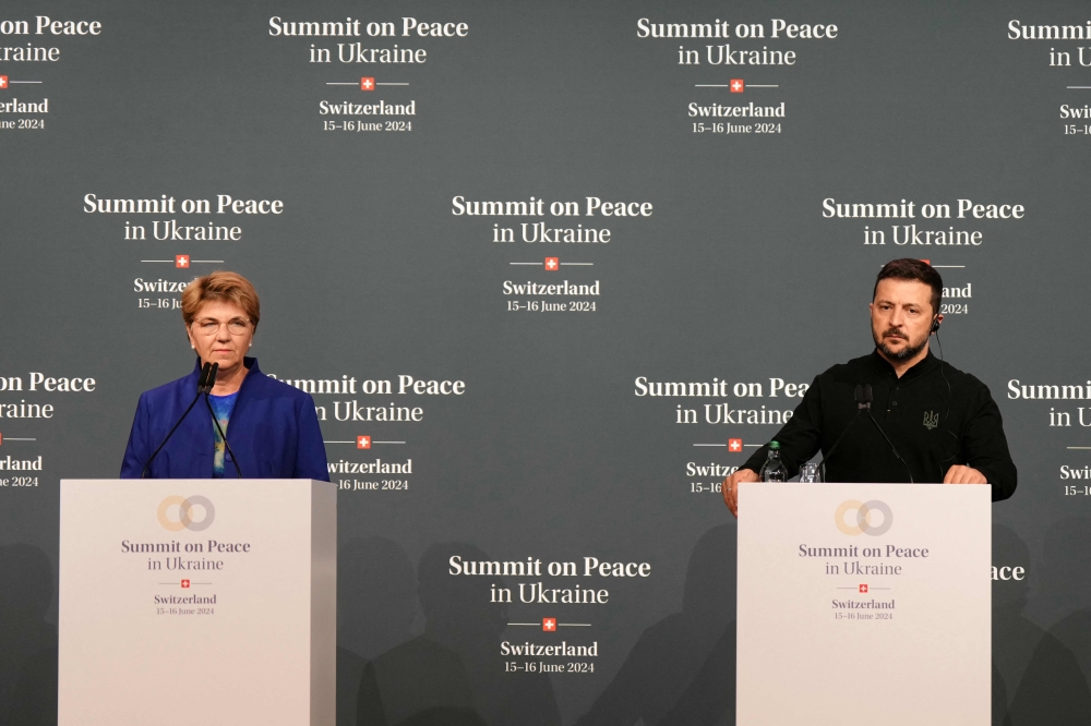 Ukrainian President Volodymyr Zelensky (R) and Swiss Federal President Viola Amherd give a press conference during a Summit on Peace in Ukraine at the luxury Burgenstock resort, near Lucerne in central Switzerland, on June 15, 2024. (Photo by Dimitar Dilkoff / AFP)