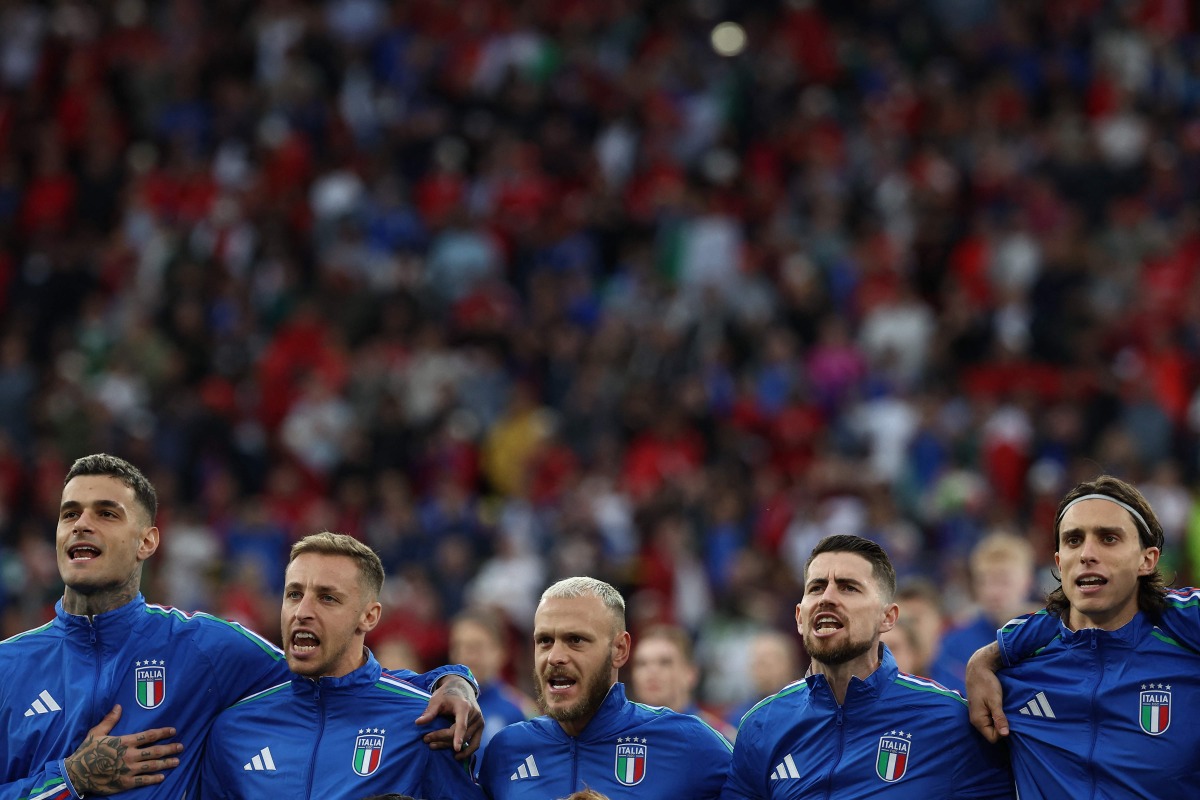 Italy's forward Gianluca Scamacca, Italy's midfielder Davide Frattesi, Italy's defender Federico Dimarco, Italy's midfielder Jorginho and Italy's defender Riccardo Calafiori sing the national anthem prior to the UEFA Euro 2024 Group B football match between Italy and Albania at the BVB Stadion in Dortmund on June 15, 2024. (Photo by FRANCK FIFE / AFP)